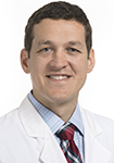 Dr. Joseph Malek, a urogynecologist at Novant Health, is pictured in a white coat. 