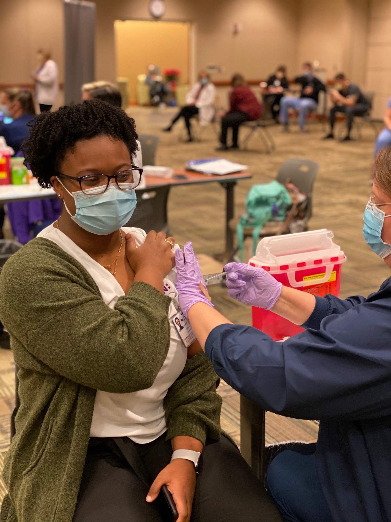 Bria Benson receives a COVID-19 vaccine.