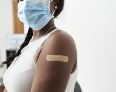 Black woman receives flu shot COVID vaccine