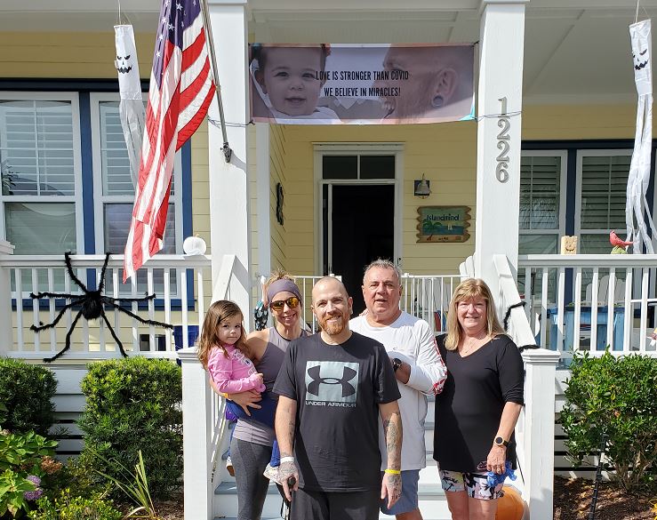 jamie calcasola COVID ecmo with family and banner