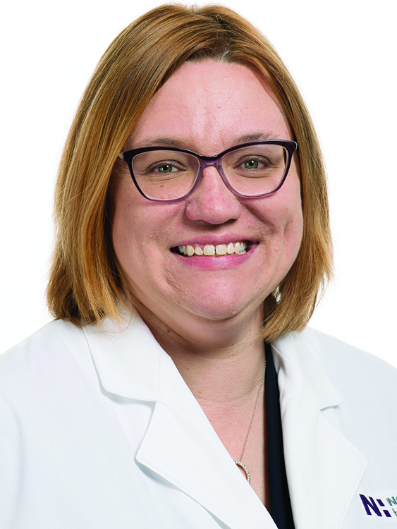 Dr. Kimberly Case smiles in a white lab coat.