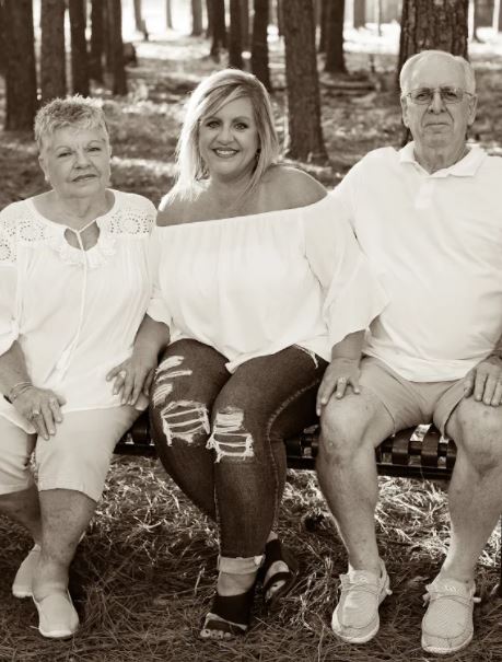 Kim Page is pictured alongside her mom, Shirley, and dad. 