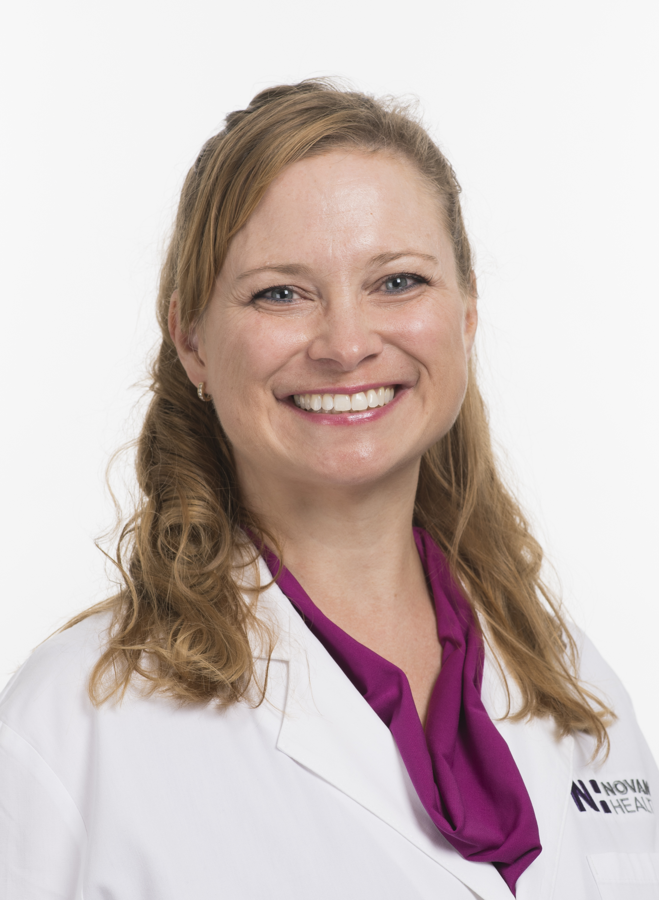 Dr. Annie Condon smiles in a white lab coat. 