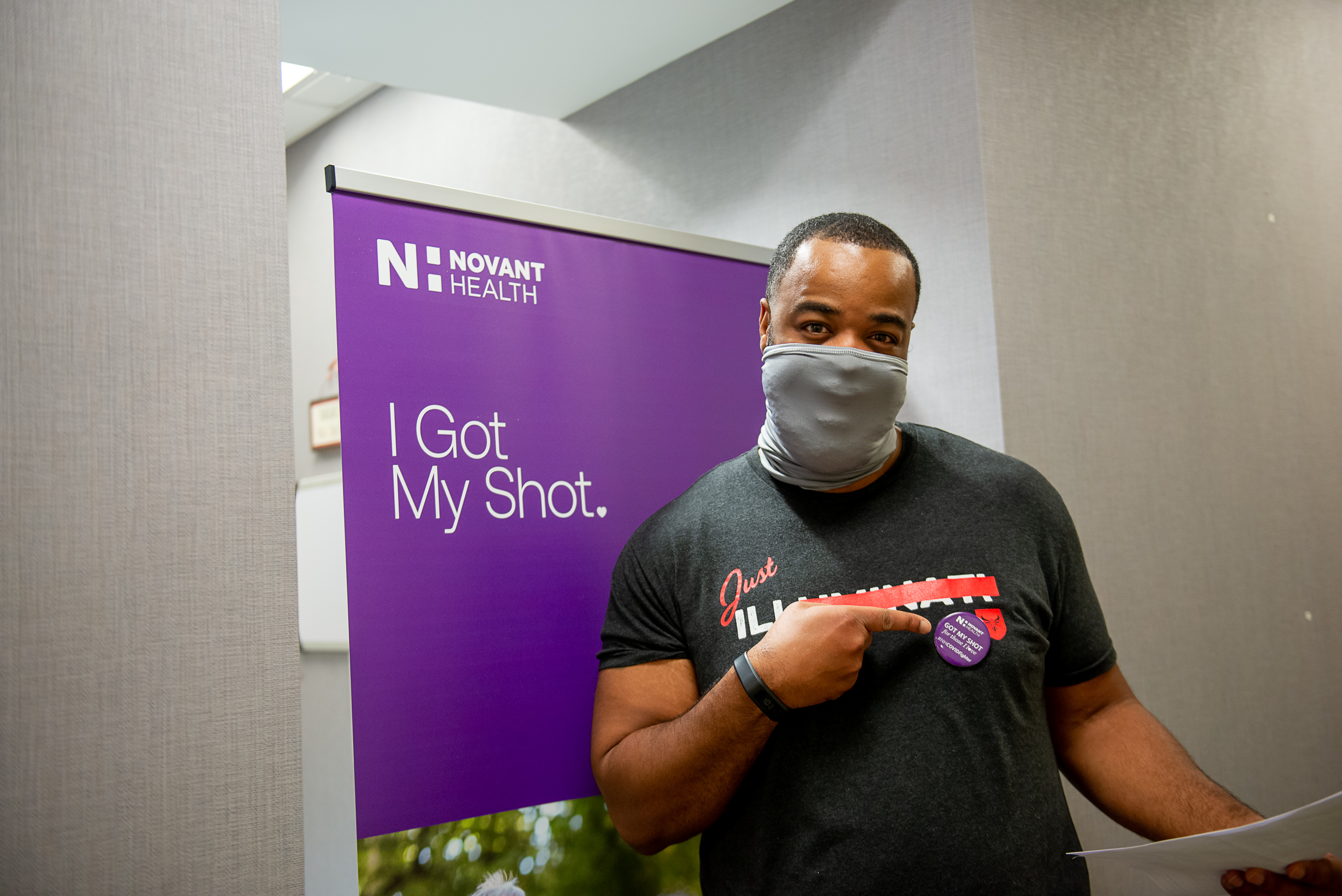 Promyse Young, 41, smiles for a photo after his first COVID-19 vaccine dose. 