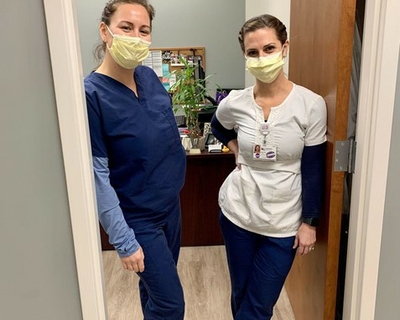Veronika Meabon (left) and Katie Long (right) standing in the doorway of their office.