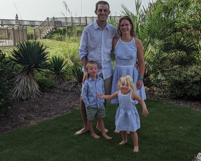 The Crossen family. Parents Kyle and Melanie, children Charlie and Laurel. Everyone is wearing light blue.