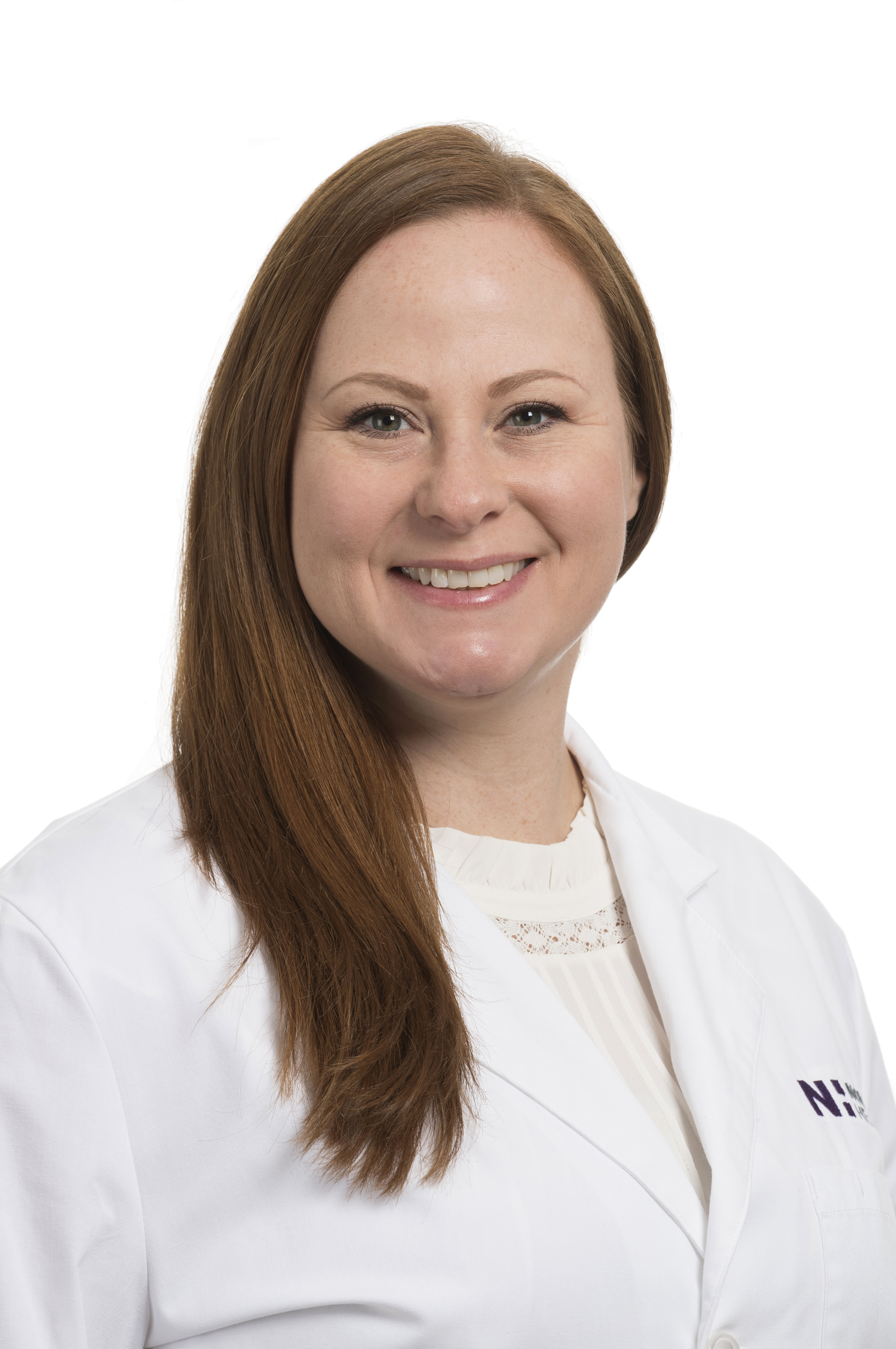 Allison Lachowitz is wearing a white lab coat and smiling into the camera.