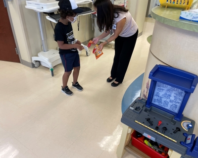 Noah Rosario and Dr. Jessica Bell snack before infusion