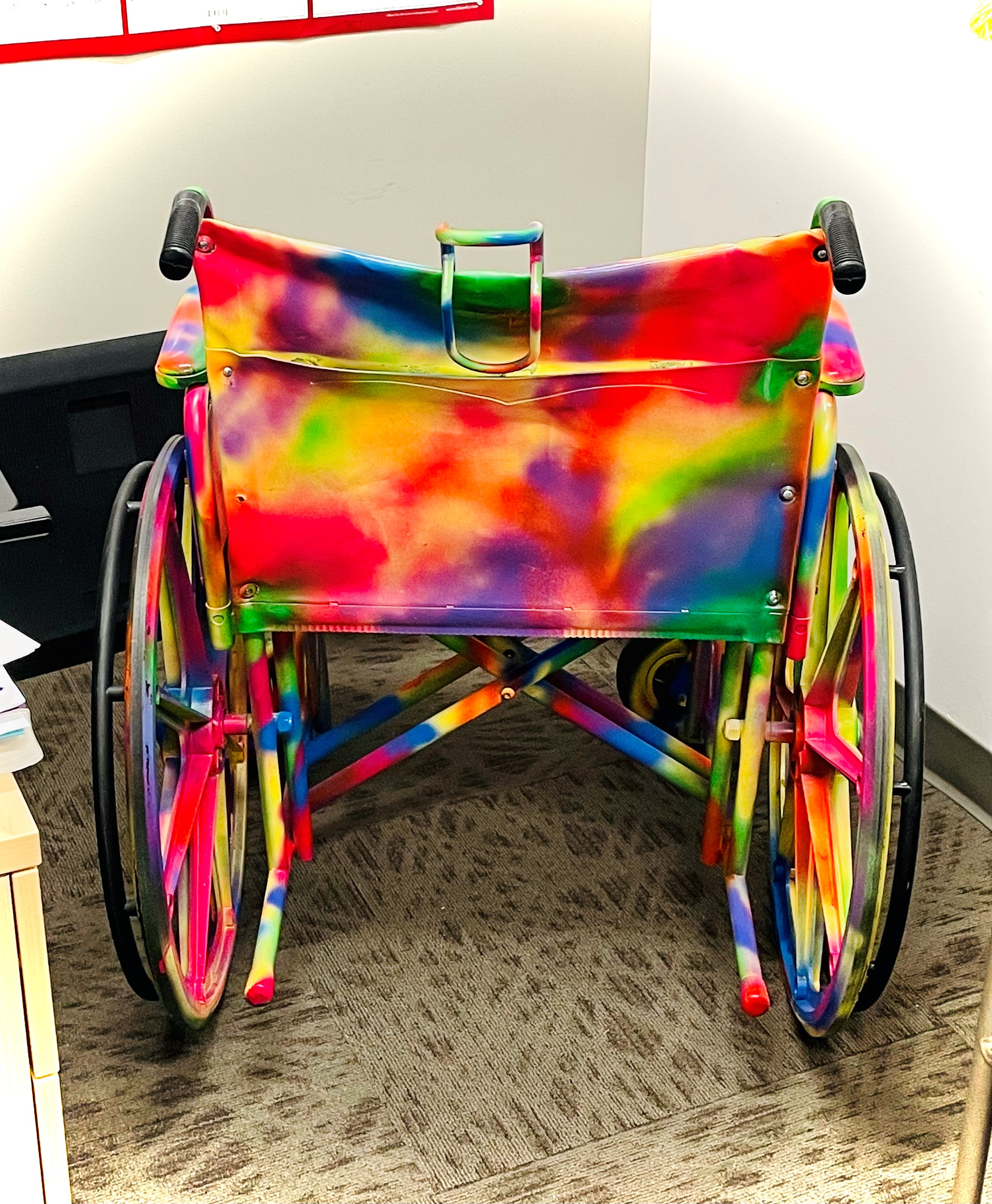 A tie-dye wheelchair that's meant to be inclusive of all LGBTQ+ patients.