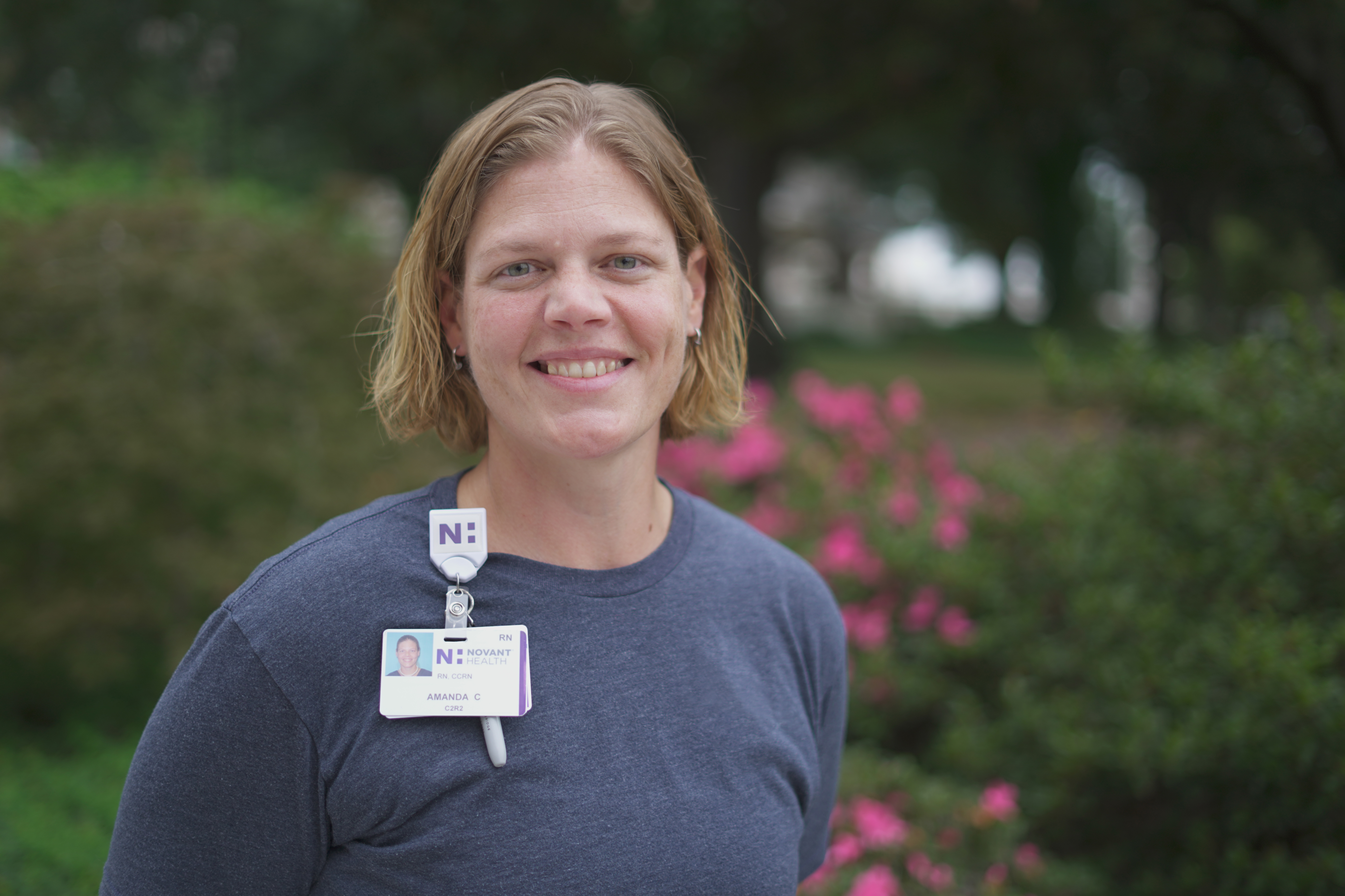 Amanda Cummings, a white female, is a critical care nurse at Novant Health who smiles for a picture. 