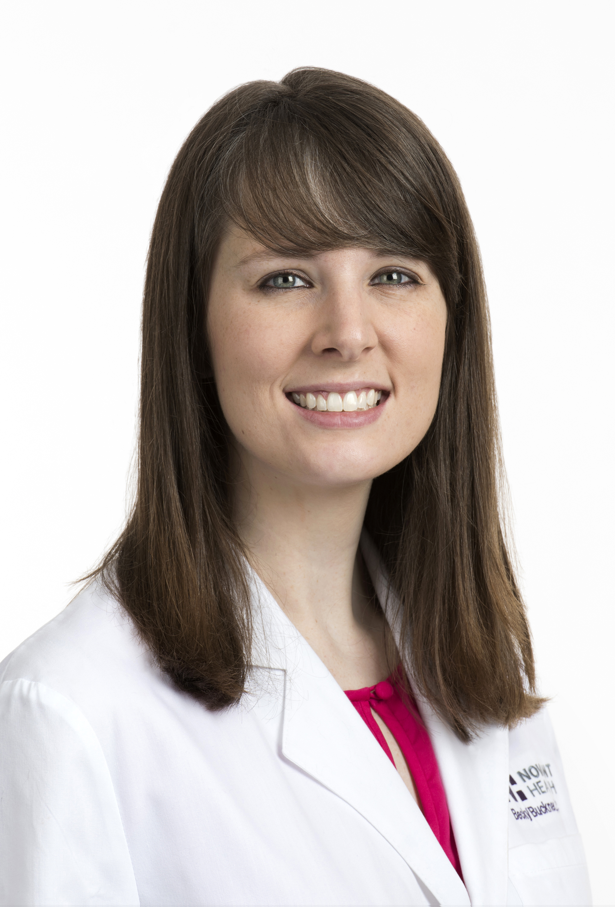 Becky DeCamillis, a physician assistant in infectious disease, smiles at the camera while wearing a white coat.