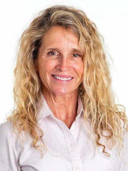 Heidi Winslow wears a white blouse and smiles at the camera