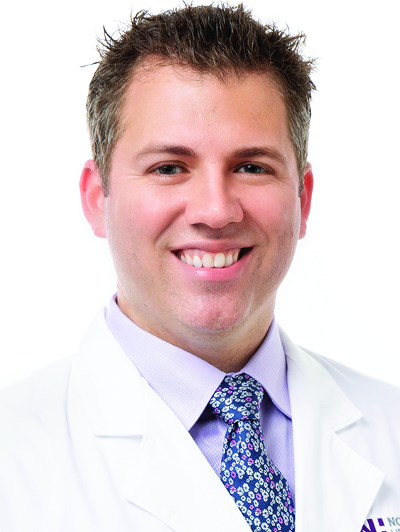 Dr. Benjamin Browning wears a white coat and smiles.