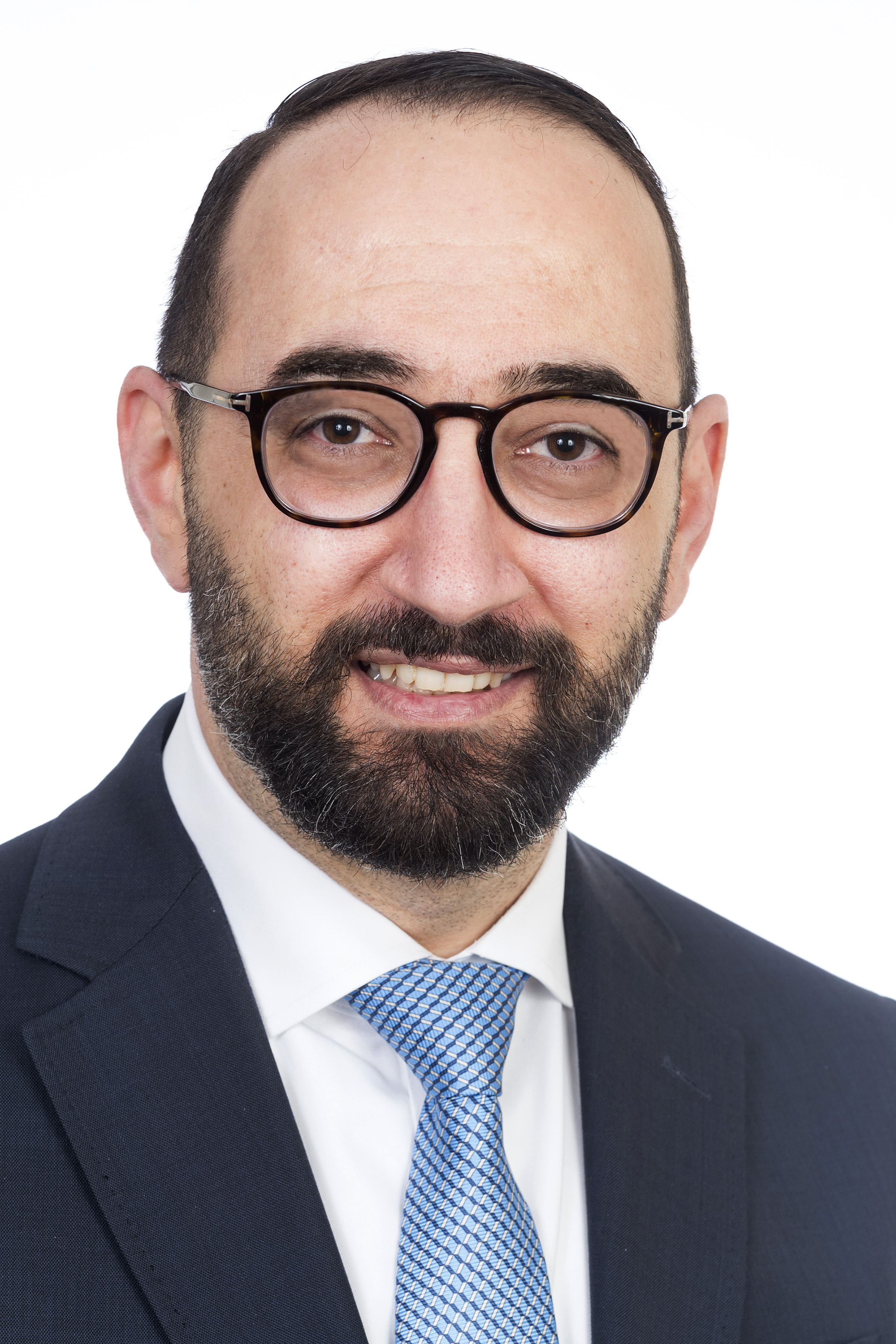 Dr. Alhosaini is wearing a blue suit and is smiling into the camera.