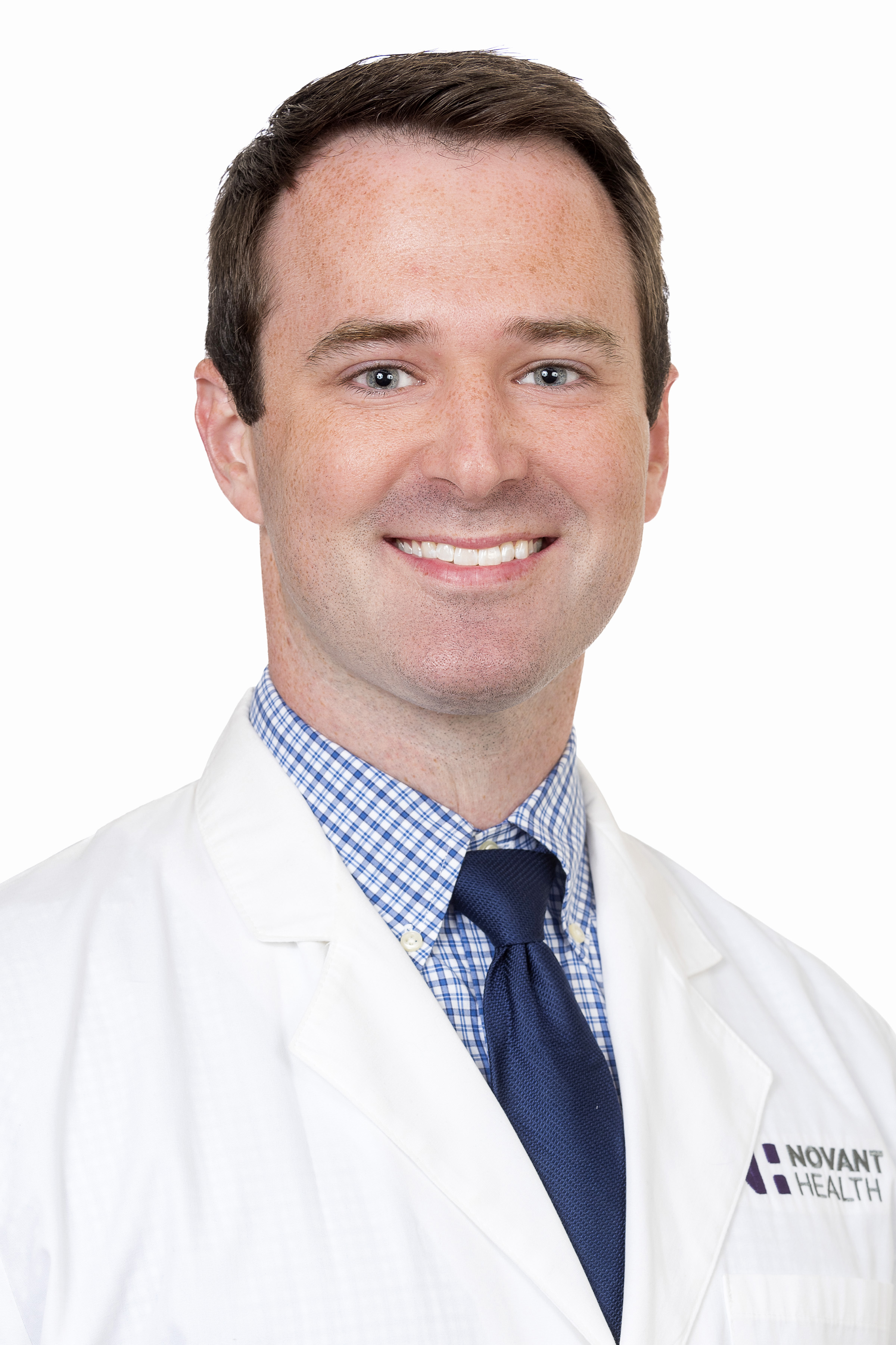 Dr. Kyle Sebastian wears white coat and smiles.