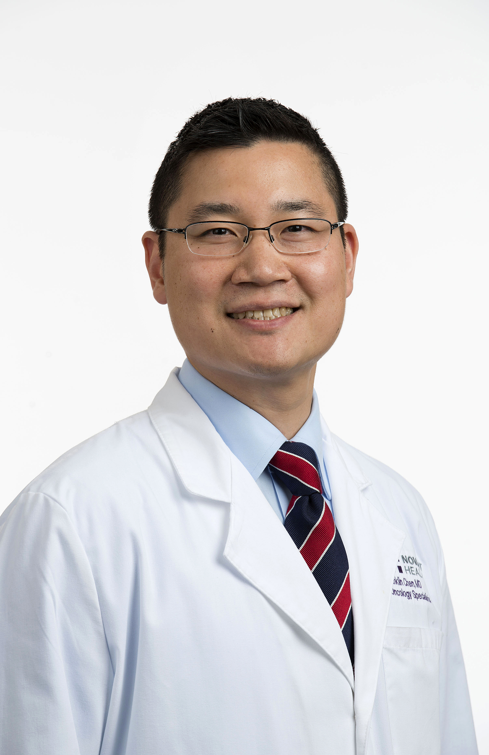 Dr. Franklin Chen wears a white coat and smiles.