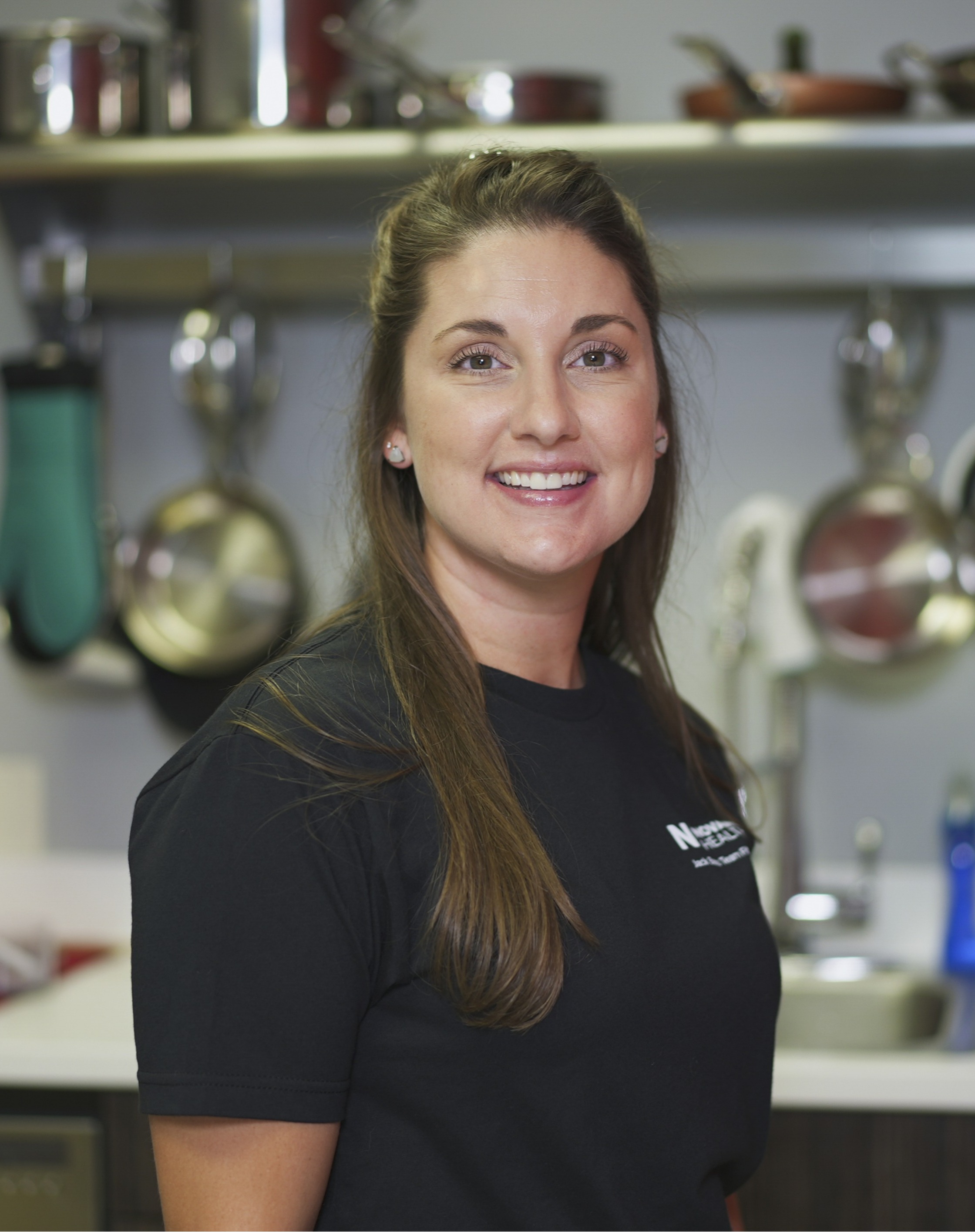Sara Parrish  wears a black shirt and smiles.