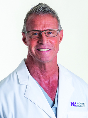 Tony Bollhorst wears a white coat and smiles.