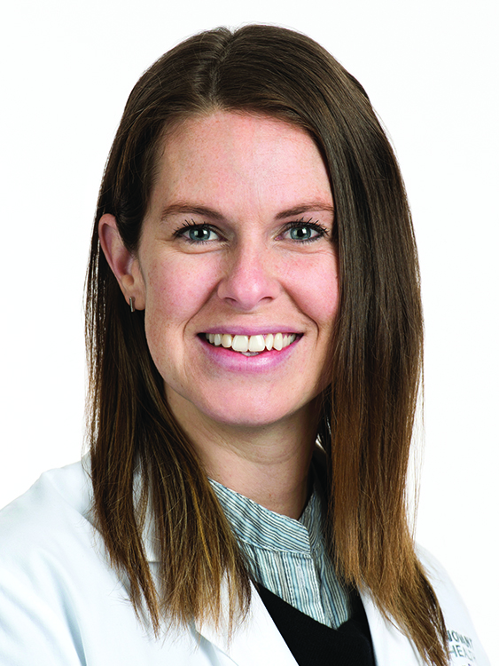 Aliza Hekman wears a white coat and smiles.