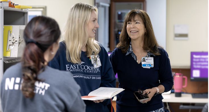 Nurse Theresa Lynn stands and talks with two women colleagues inside East Cooper Medical Center.