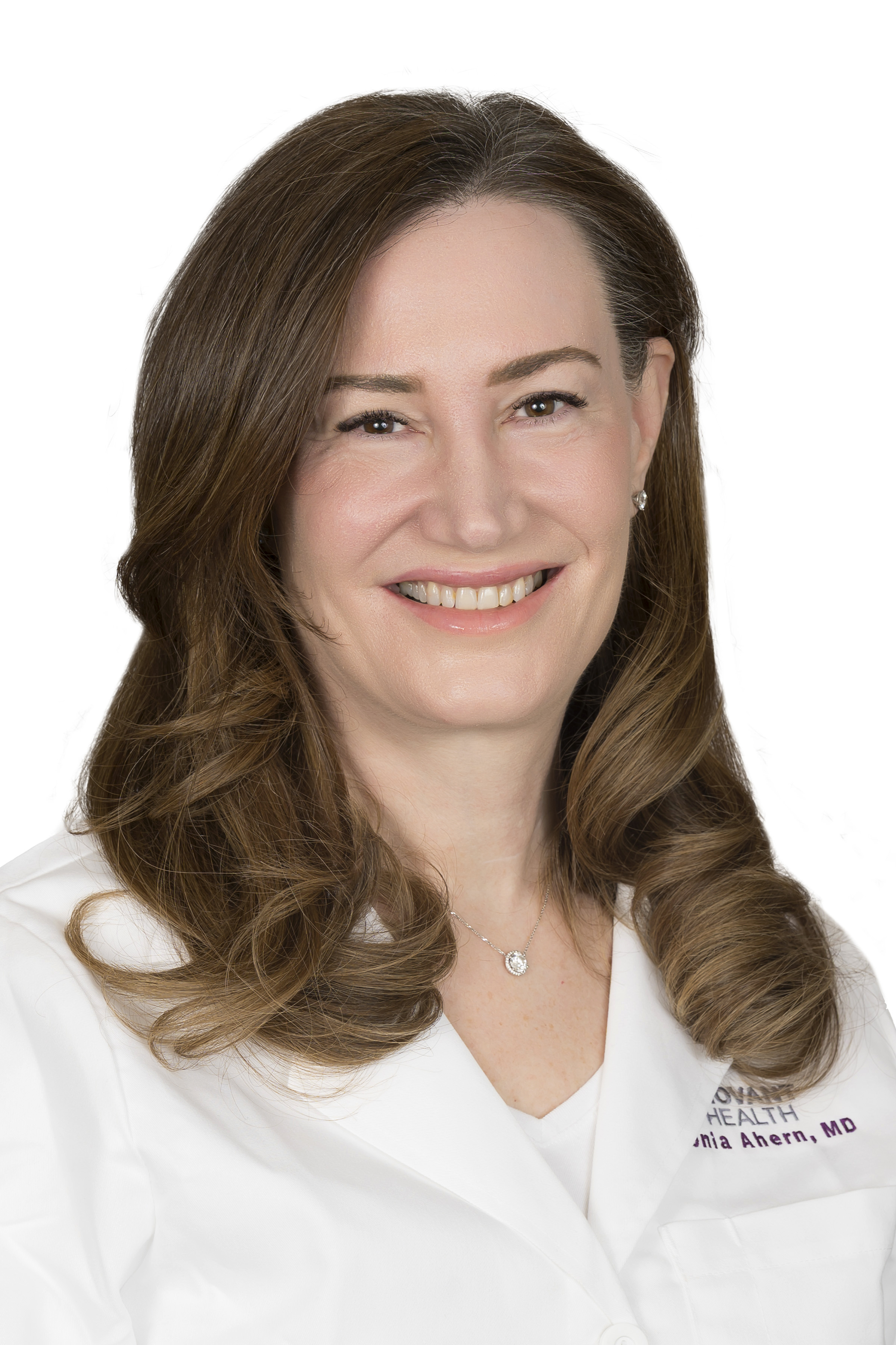 Dr. Toni Ahern wears a white coat and smiles.