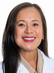 Dr. Thao Nguyen wears a white coat and smiles.