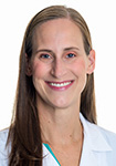 Dr. Jennifer Haag wears a white coat and smiles.