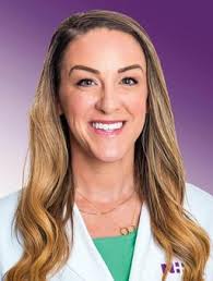 Carolina McCalmon wears a white coat and smiles.