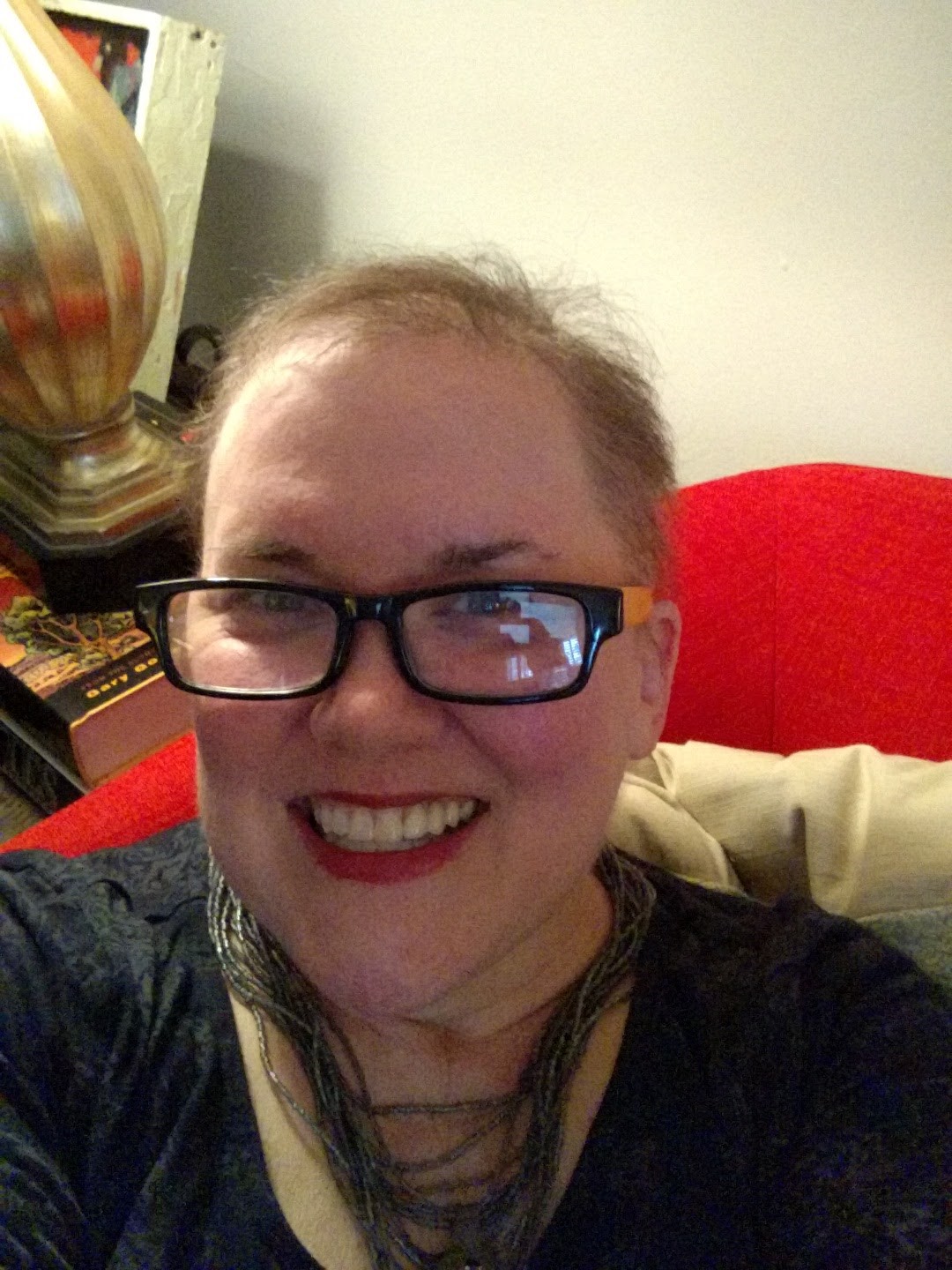 Page Leggett smiles at the camera. She has short fuzz for hair following cancer treatments.