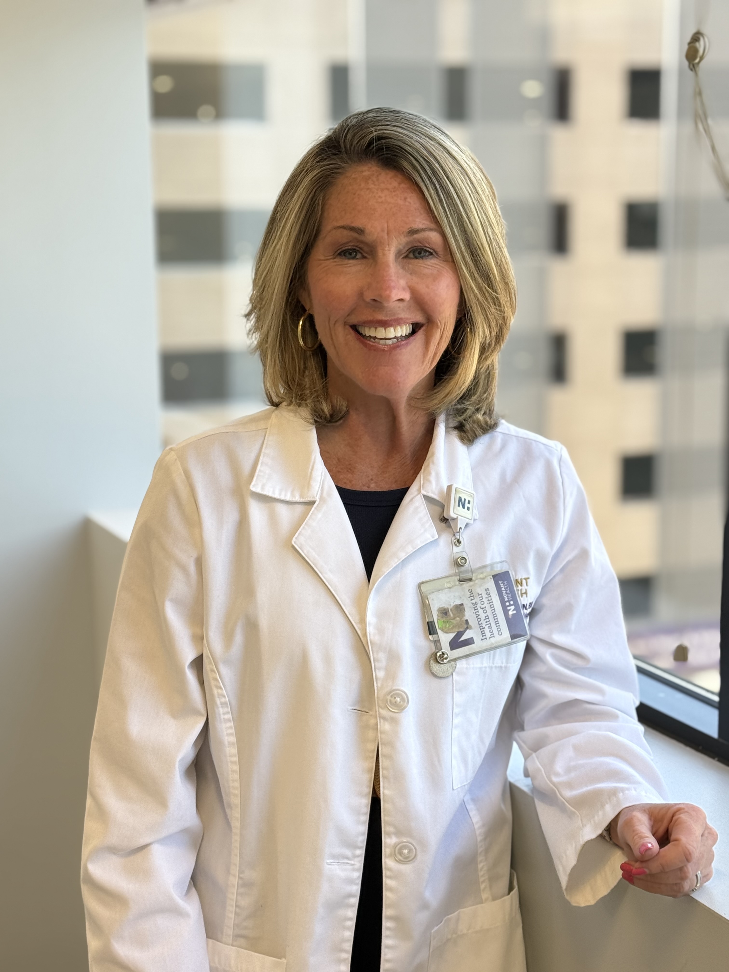 Vicki Davidson wears a white coat and smiles.
