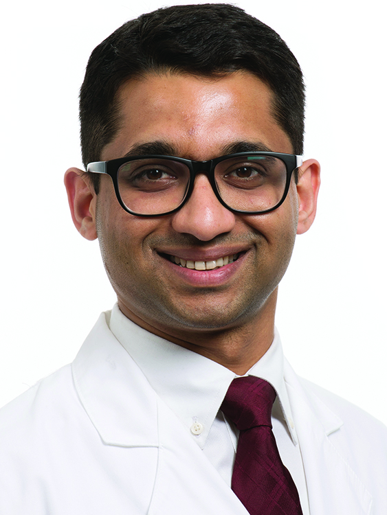 Dr. Kaustubh Dabhadkar wears a white coat and smiles.