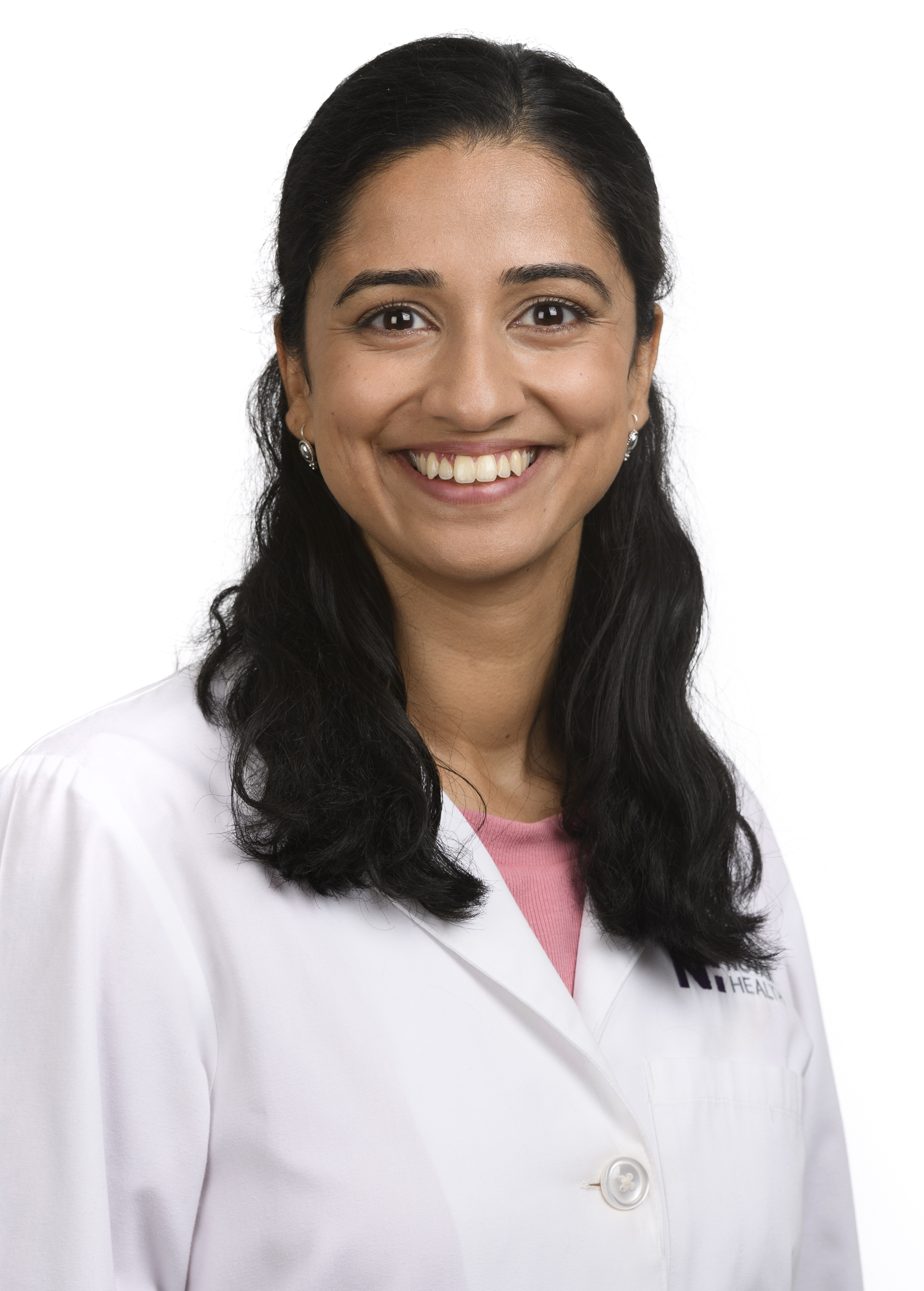 Dr. Vaishnavi Gadicharla wears a white coat and smiles.