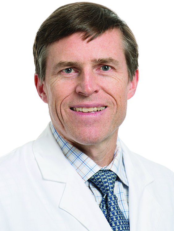 Dr. David Homesley wears a white coat and smiles.