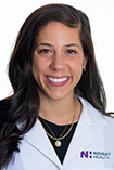 Adrienne Montero wears a white coat and smiles.