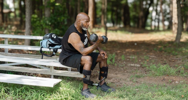 Omar McNeil does a bicep curl with a dumbbell. 