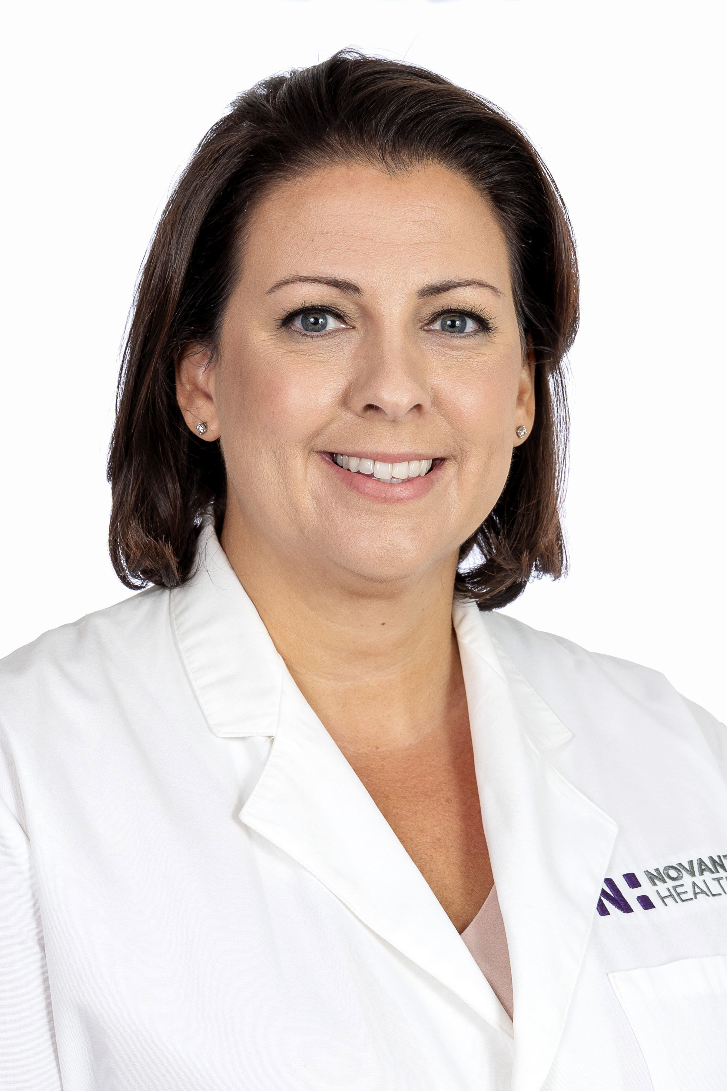 Dr. Natalie Rochester wears a white coat and smiles.