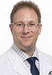 Dr. Seth Richman wears a white coat and smiles.