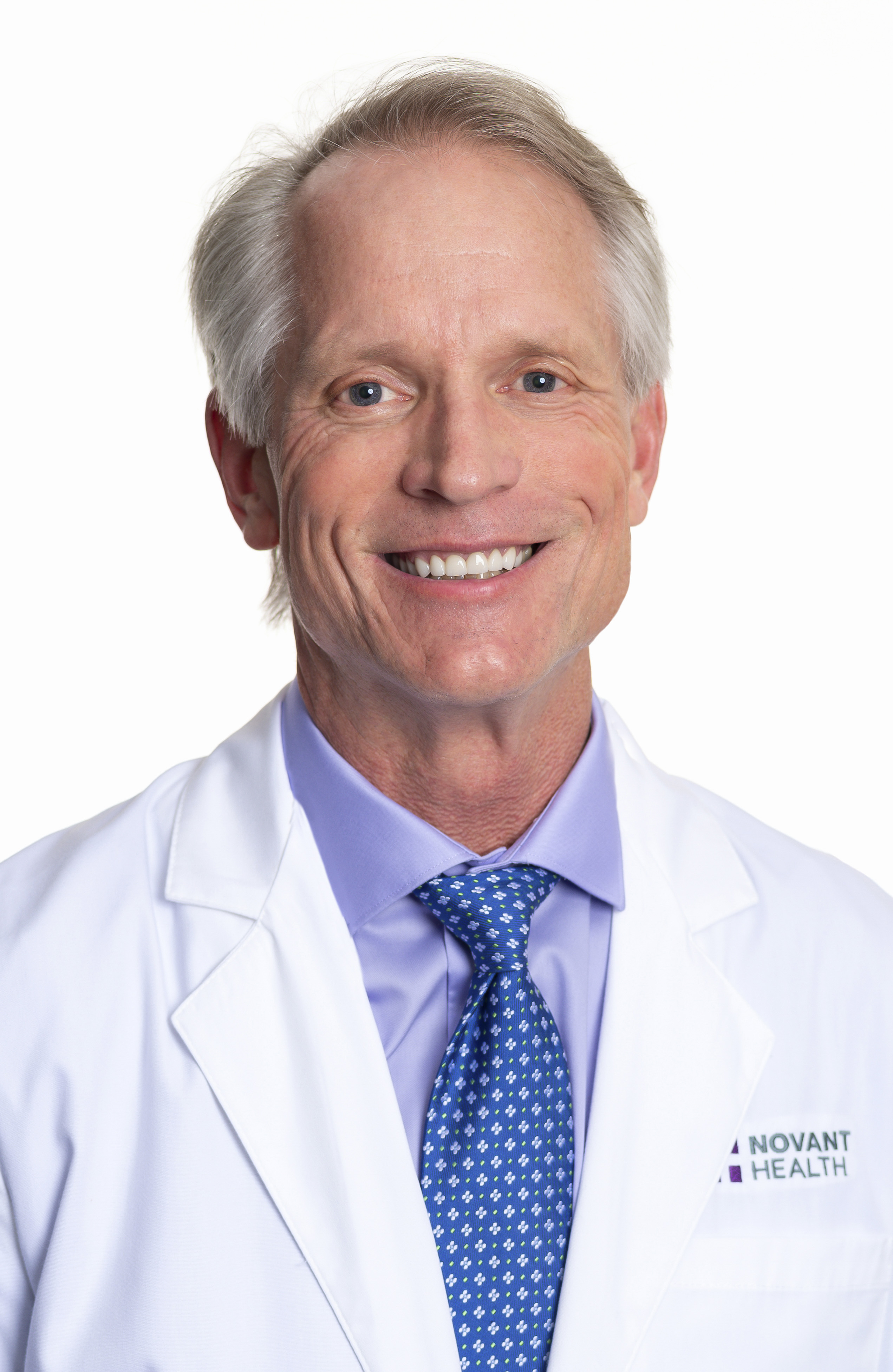 Dr. Timothy Chase wears a white coat and smiles.