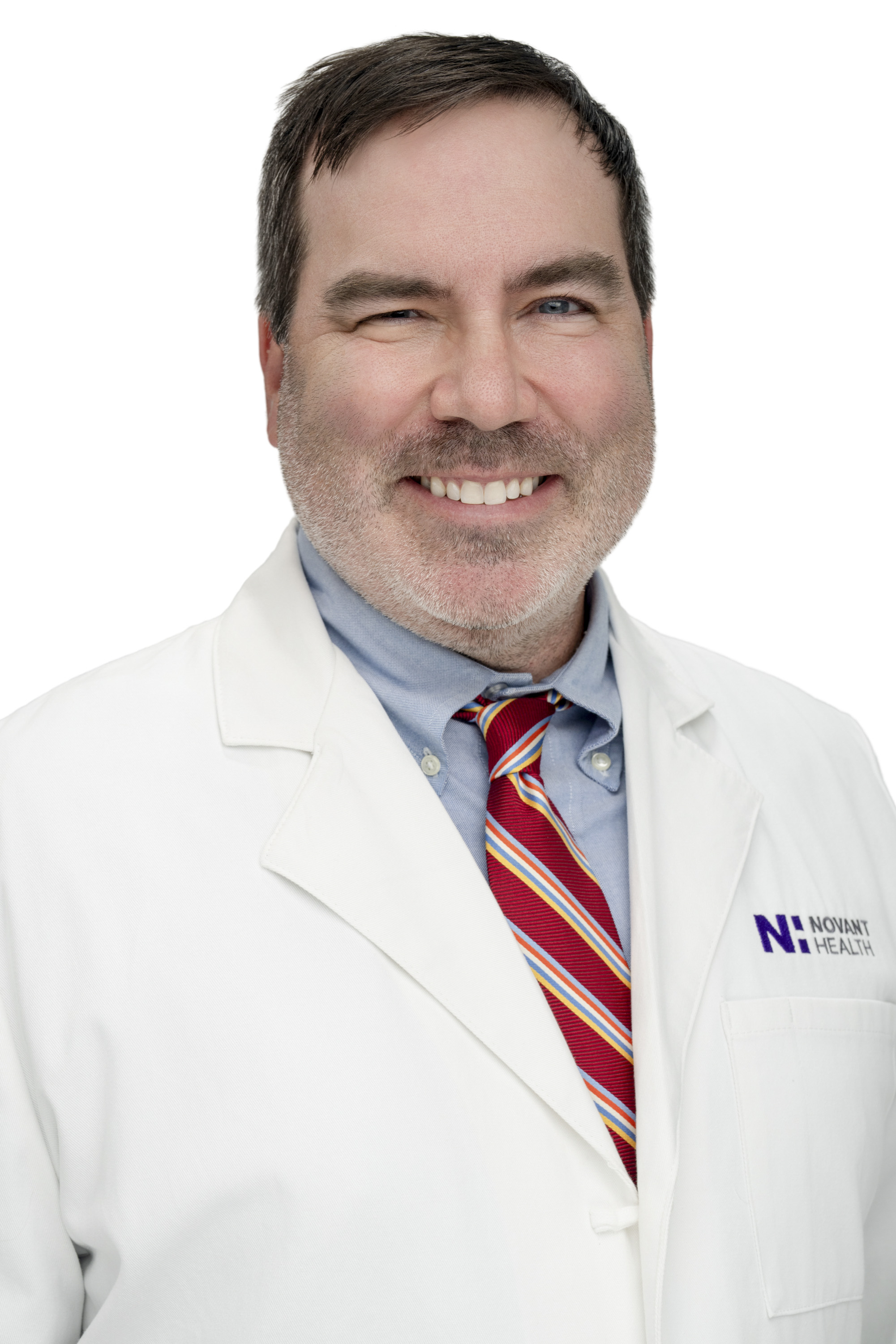 Dr. Chris Culpepper wears a white coat and smiles.