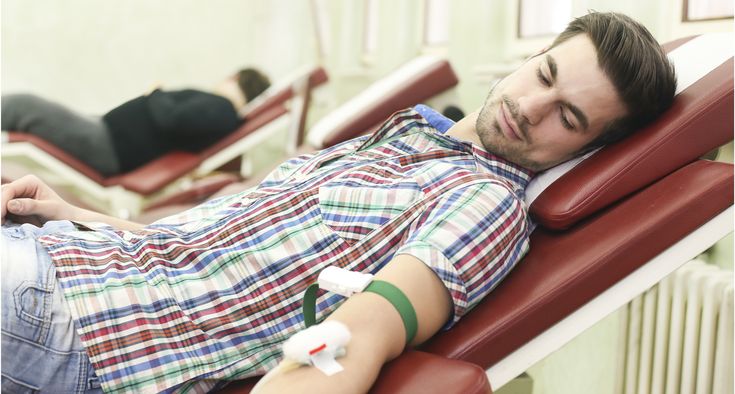 A young man is donating blood.