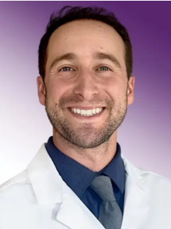 Dr. Simon Moskowitz wears a white coat and smiles.