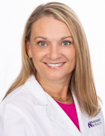 Dr. Natalie Gregory wears a white coat and smiles.