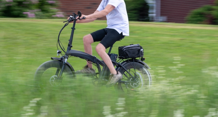 A man rides an electronic bike.