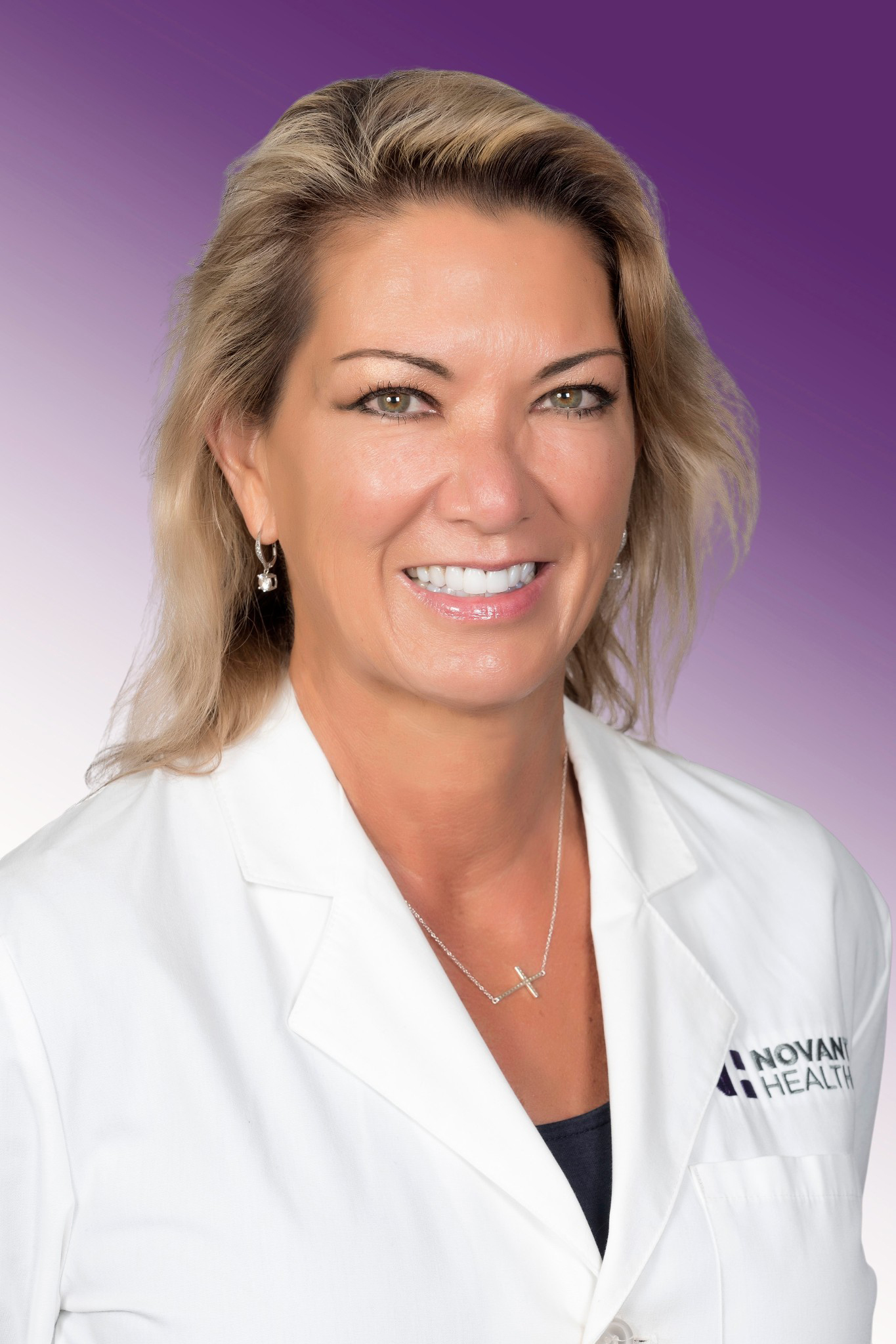Dr. Lori Kellam wears a white coat and smiles.