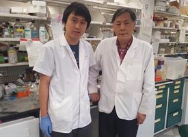 environmental portrait of two Asian males in a science lab