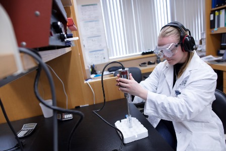 blonde female student using a sonifer in a science lab