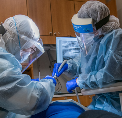 Dental Assistant with Dentist treating a patient