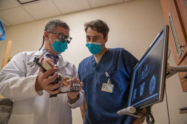 Dr. Carlo Ercoli works with prosthodontic resident