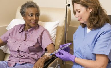 Black female patient with white female nurse getting an infusion