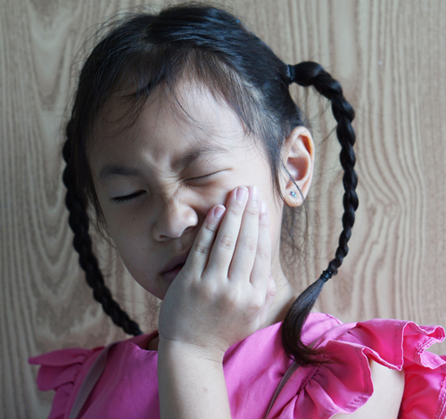 girl in obvious mouth pain
